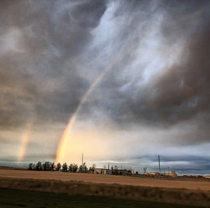 Rainbows over the Raymond Prairies in Alberta Canada